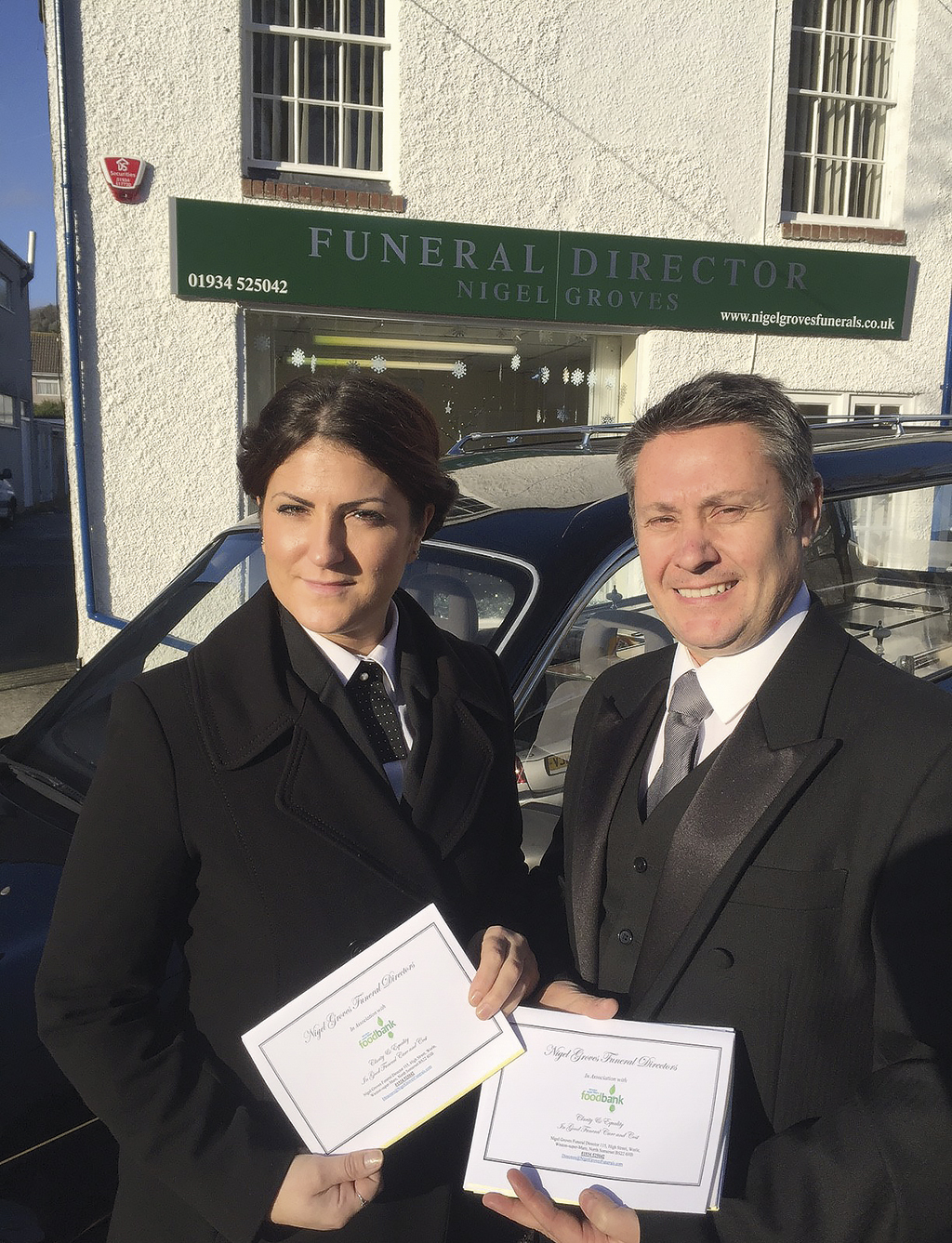 Claire and Nigel holding Funeral Bank Vouchers