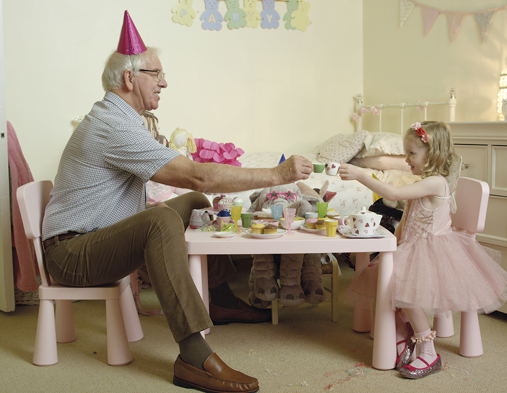 A still of a grandfather enjoying tea with his granddaughter from the National Ad campaign 2016
